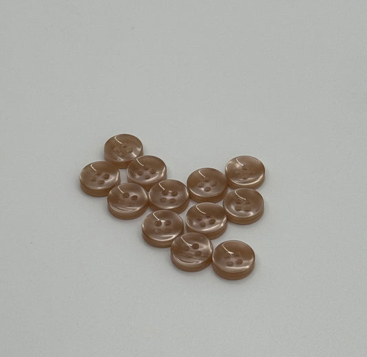Close-up image of Warm Sand - Light Brown Iridescent 18-Ligne Button, a premium quality button.