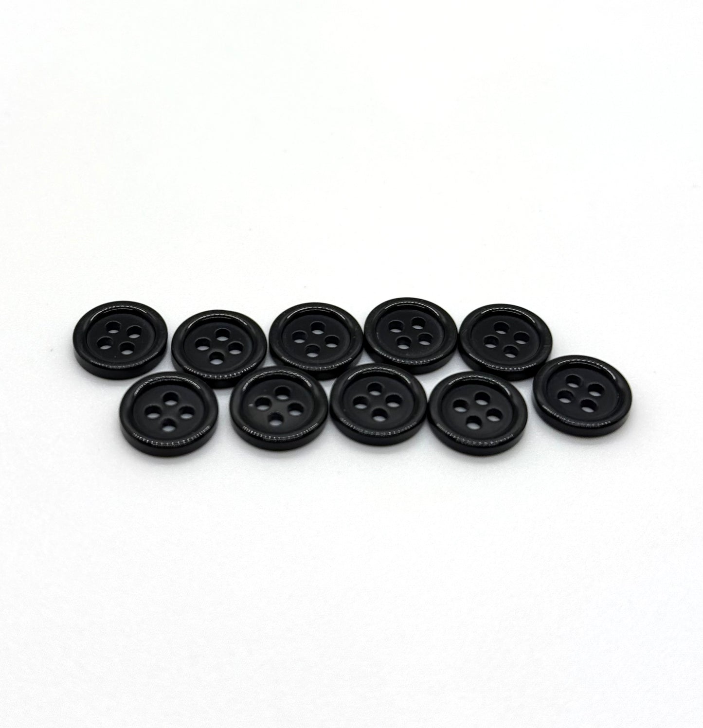 Close-up image of Black Pie Crust Polymer Button, a premium quality button.