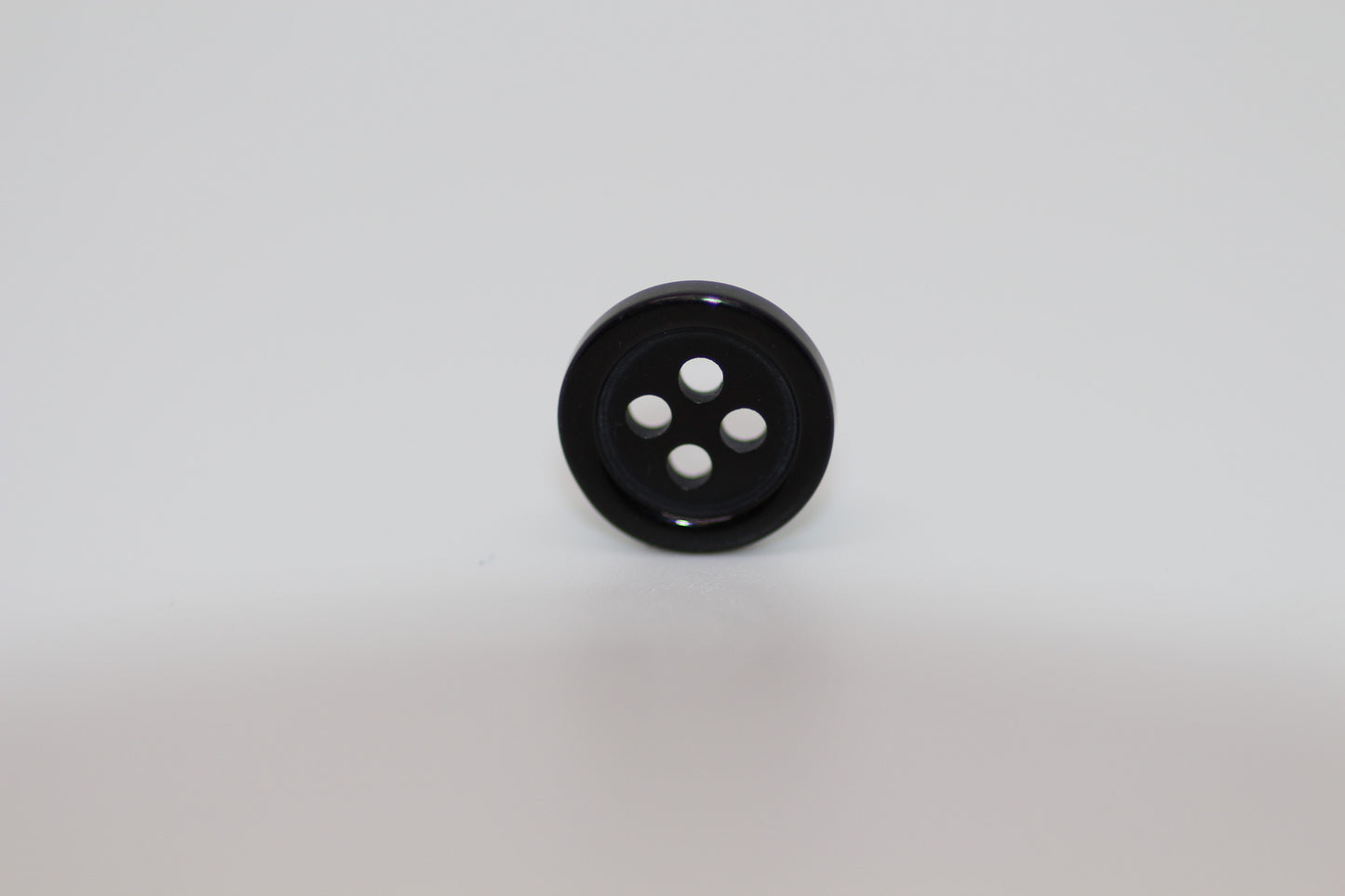 Close-up image of Black Pie Crust Polymer Button, a premium quality button.