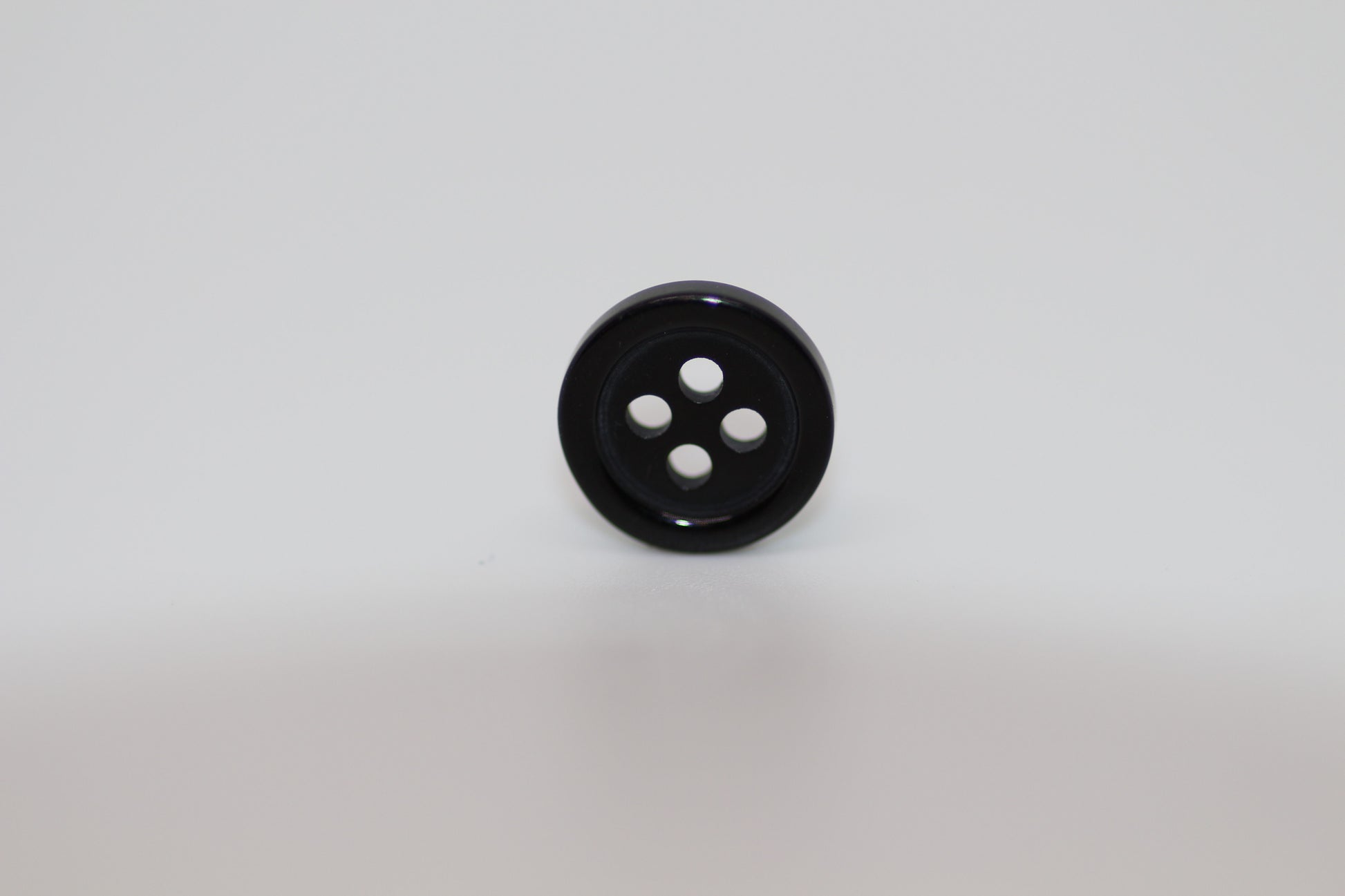 Close-up image of Black Pie Crust Polymer Button, a premium quality button.