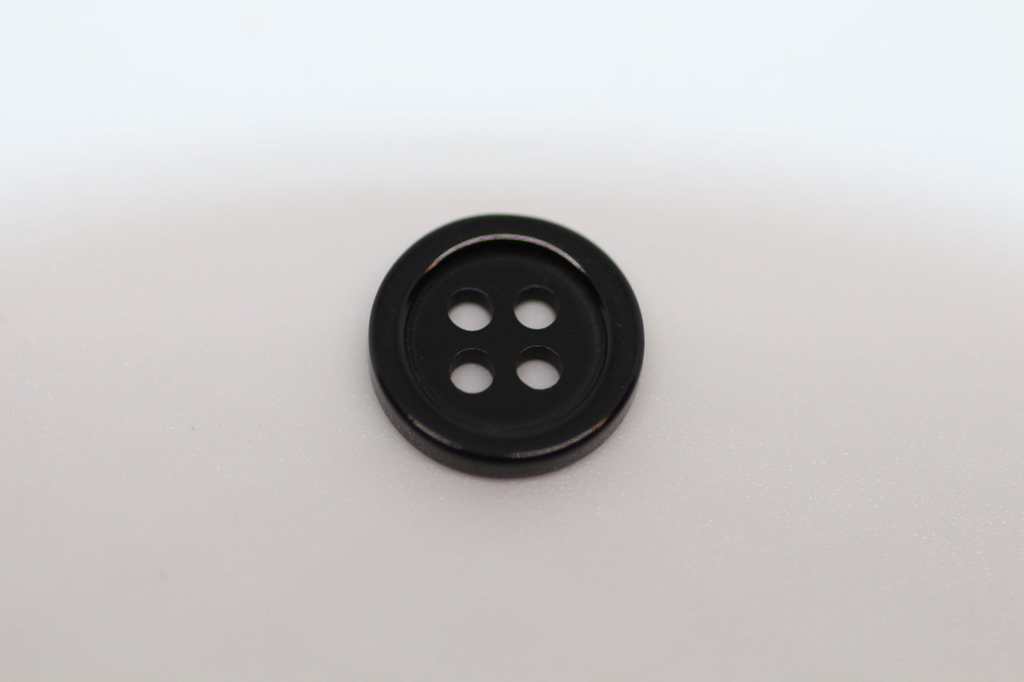 Close-up image of Black Pie Crust Polymer Button, a premium quality button.