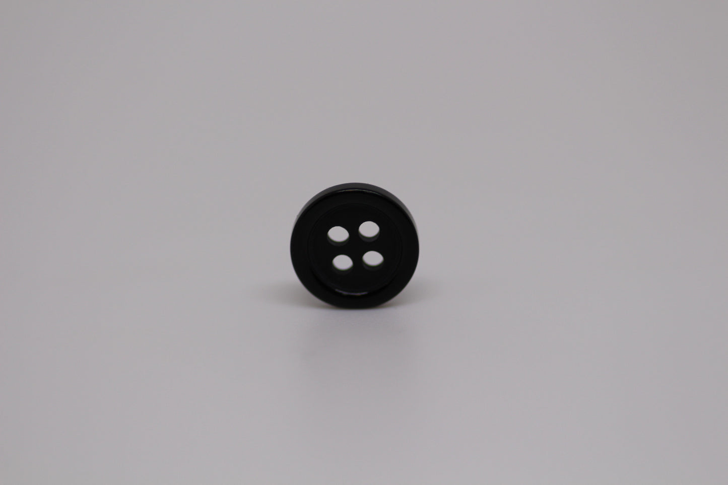 Close-up image of Black Pie Crust Polymer Button, a premium quality button.