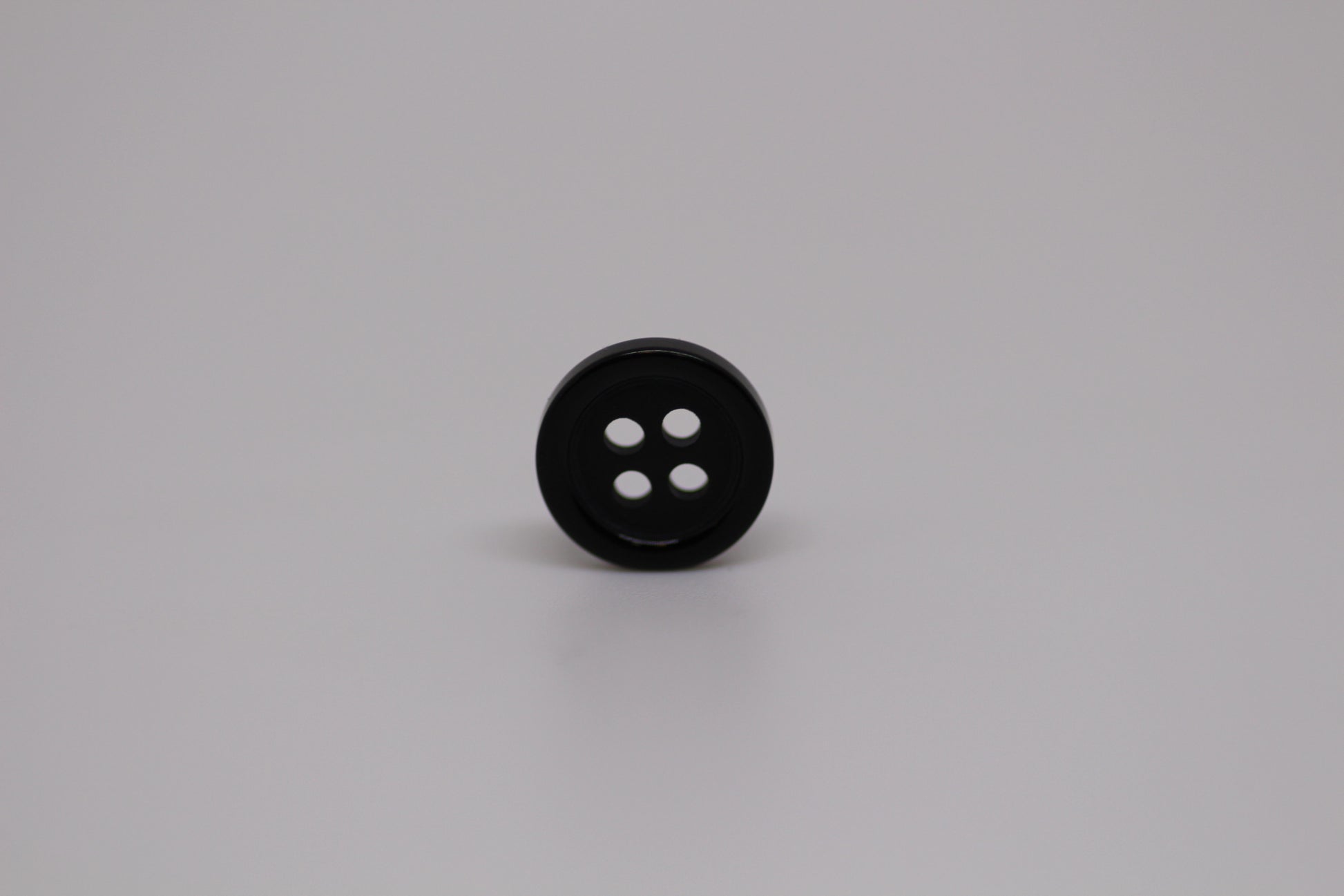 Close-up image of Black Pie Crust Polymer Button, a premium quality button.