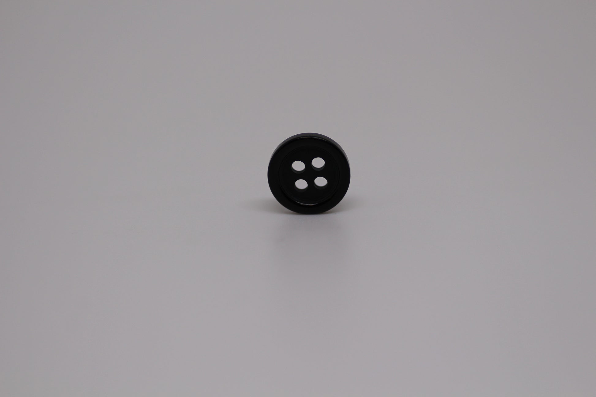 Close-up image of Black Pie Crust Polymer Button, a premium quality button.