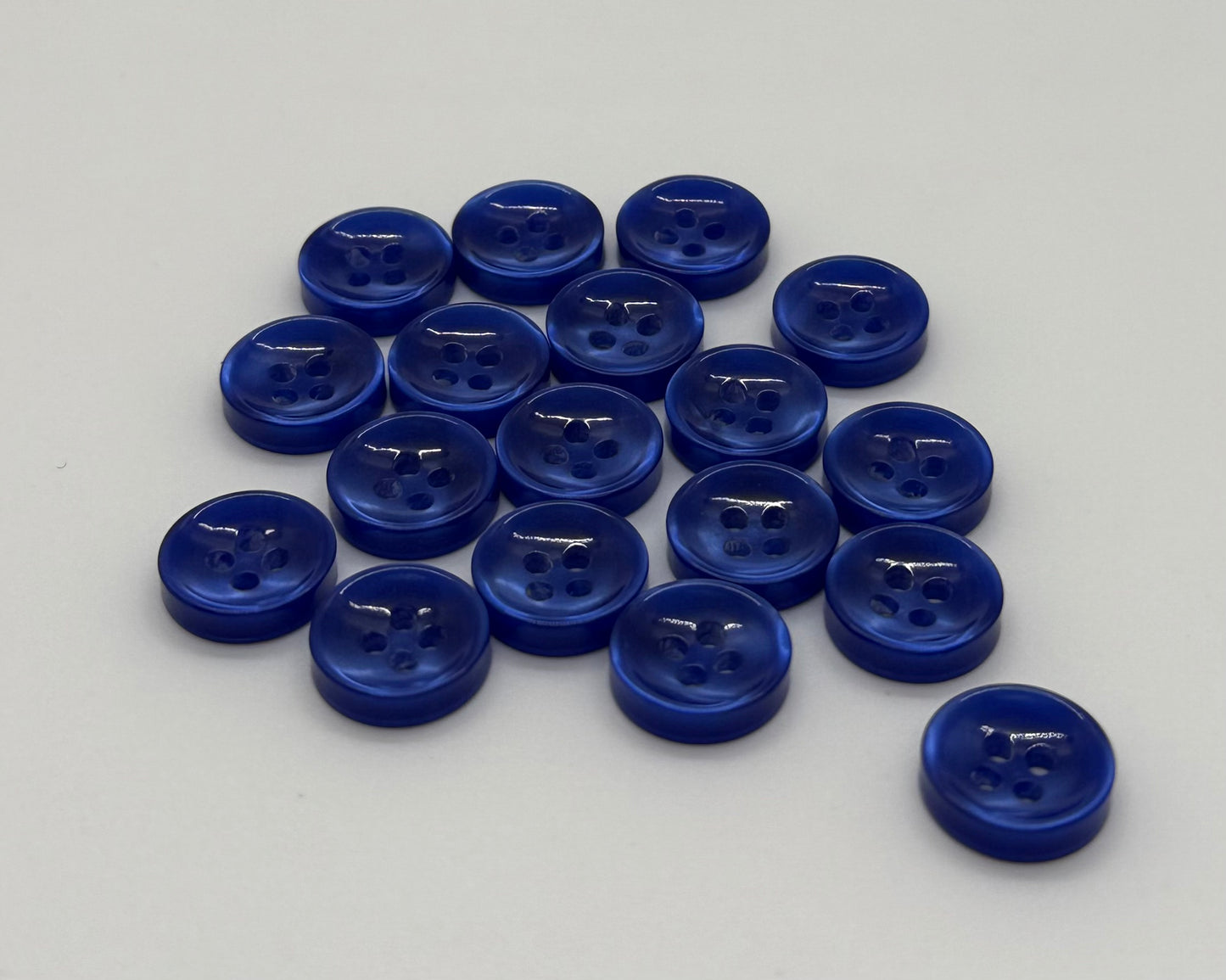 Close-up image of Azure Mirage - Blue Iridescent 18-Ligne Button, a premium quality button.