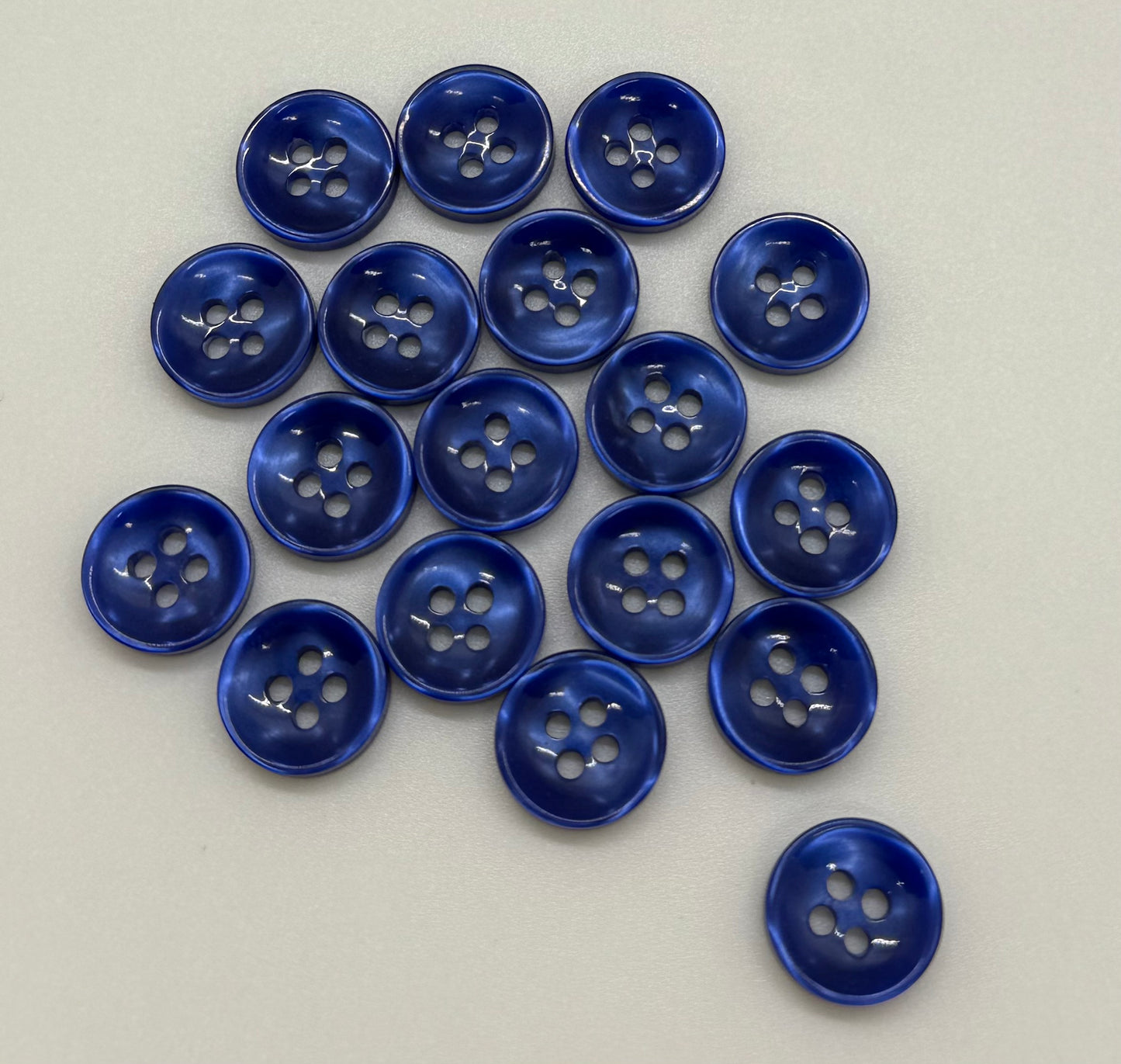 Close-up image of Azure Mirage - Blue Iridescent 18-Ligne Button, a premium quality button.