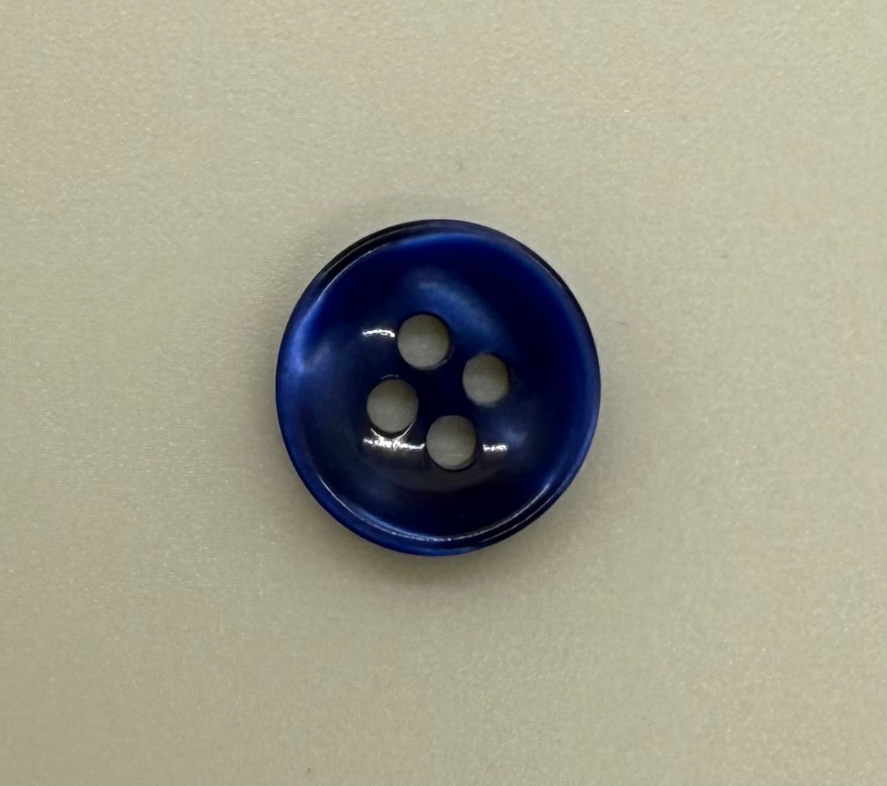 Close-up image of Azure Mirage - Blue Iridescent 18-Ligne Button, a premium quality button.