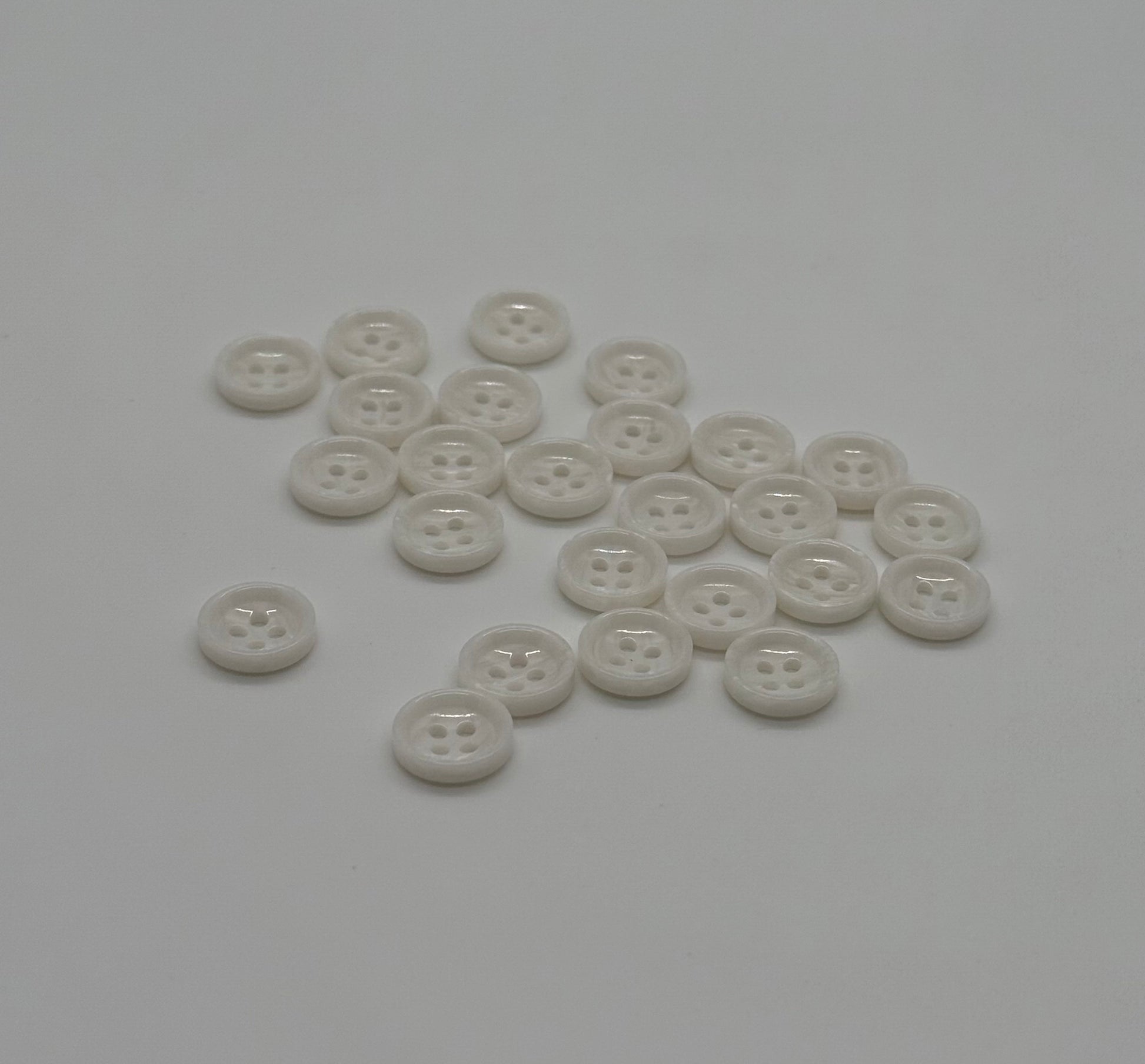 Close-up image of White Marble Crest Dimple Button, a premium quality button.