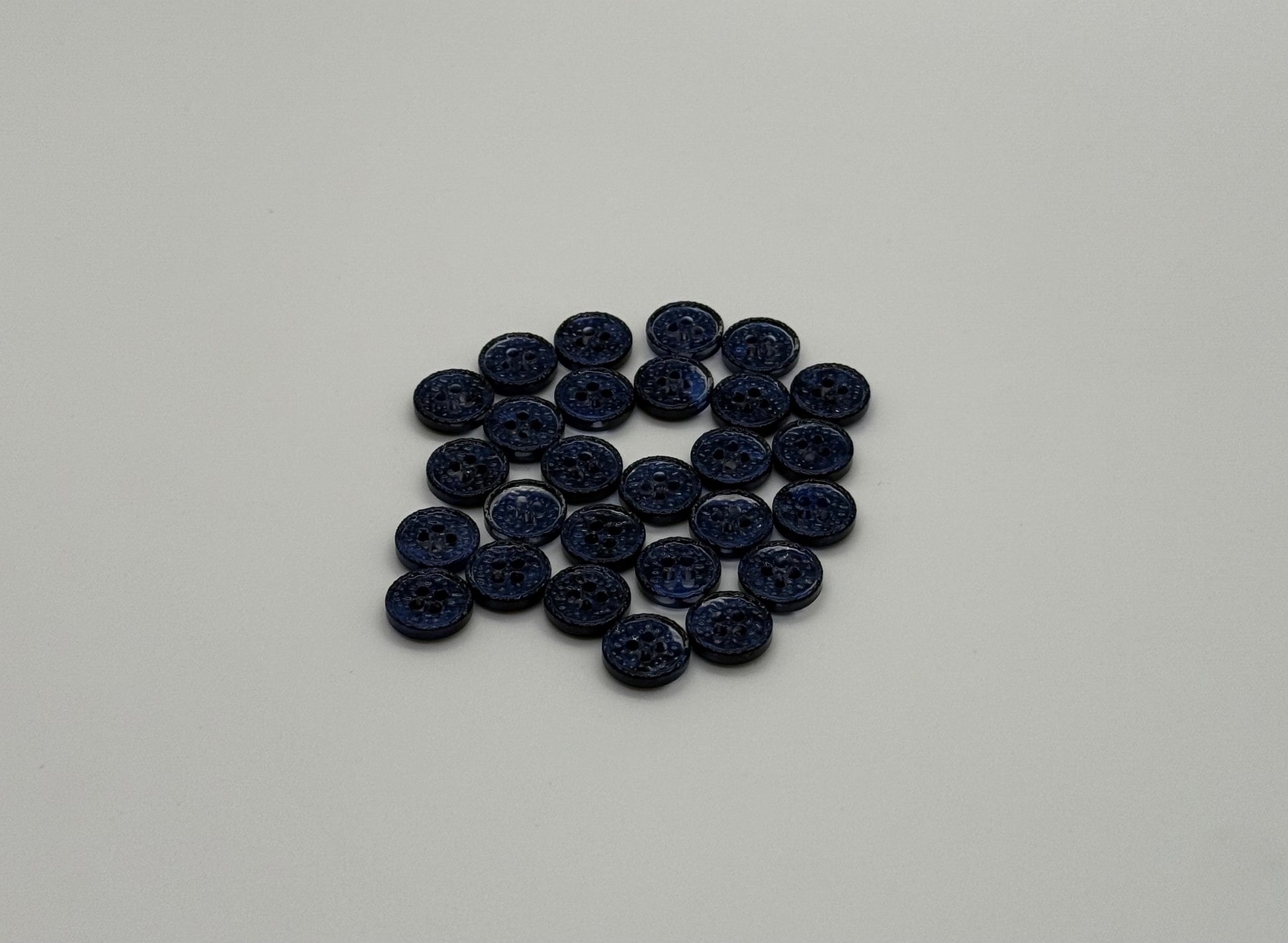 Close-up image of Midnight Spark Fancy 4-Hole Button, a premium quality button.