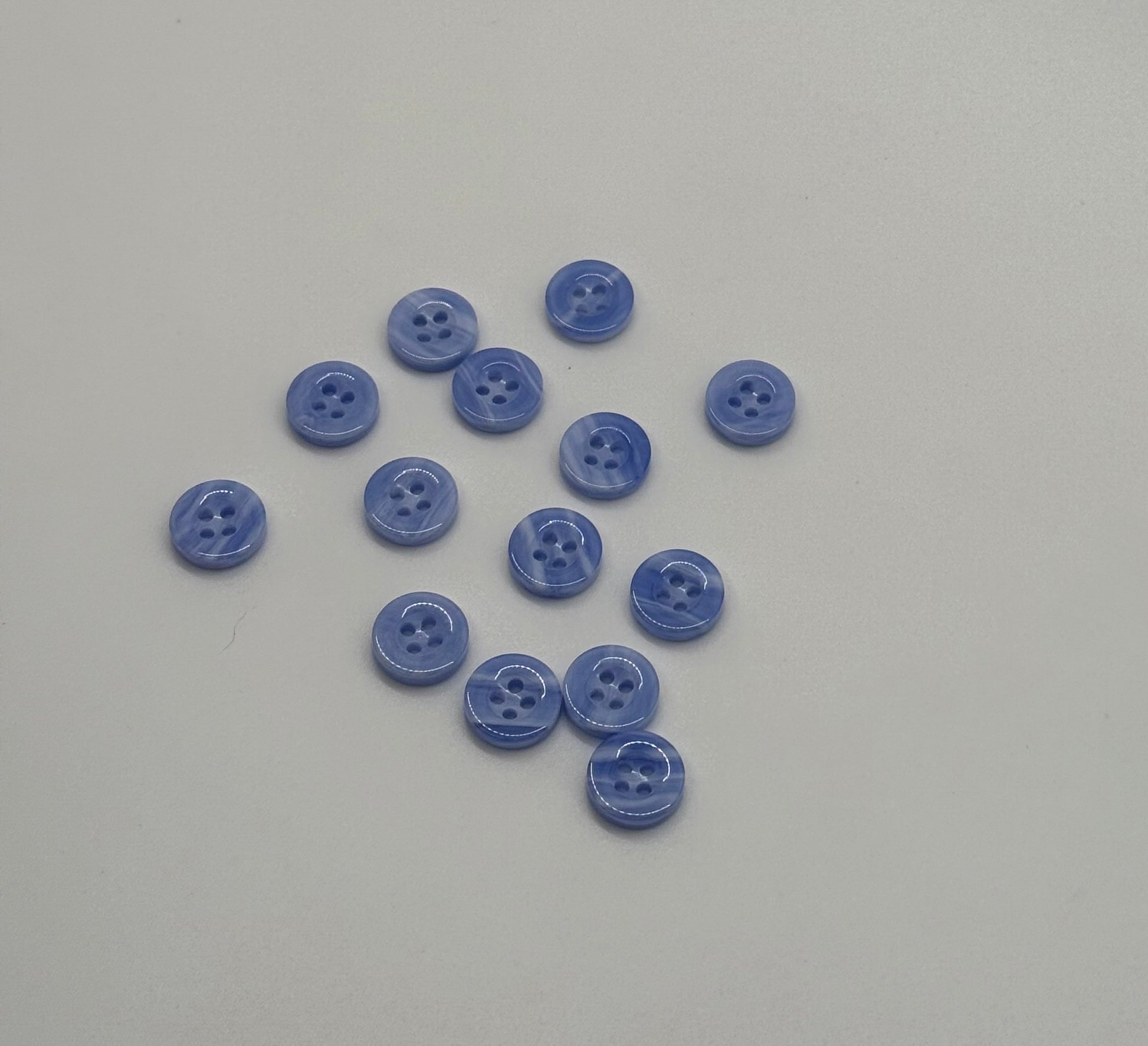 Close-up image of Sky Drift - Cloudy Blue 18L Button, a premium quality button.