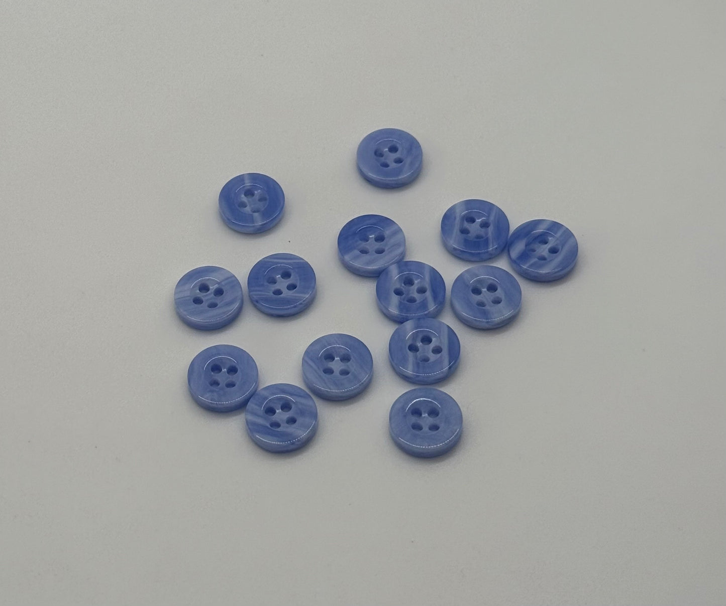 Close-up image of Sky Drift - Cloudy Blue 18L Button, a premium quality button.