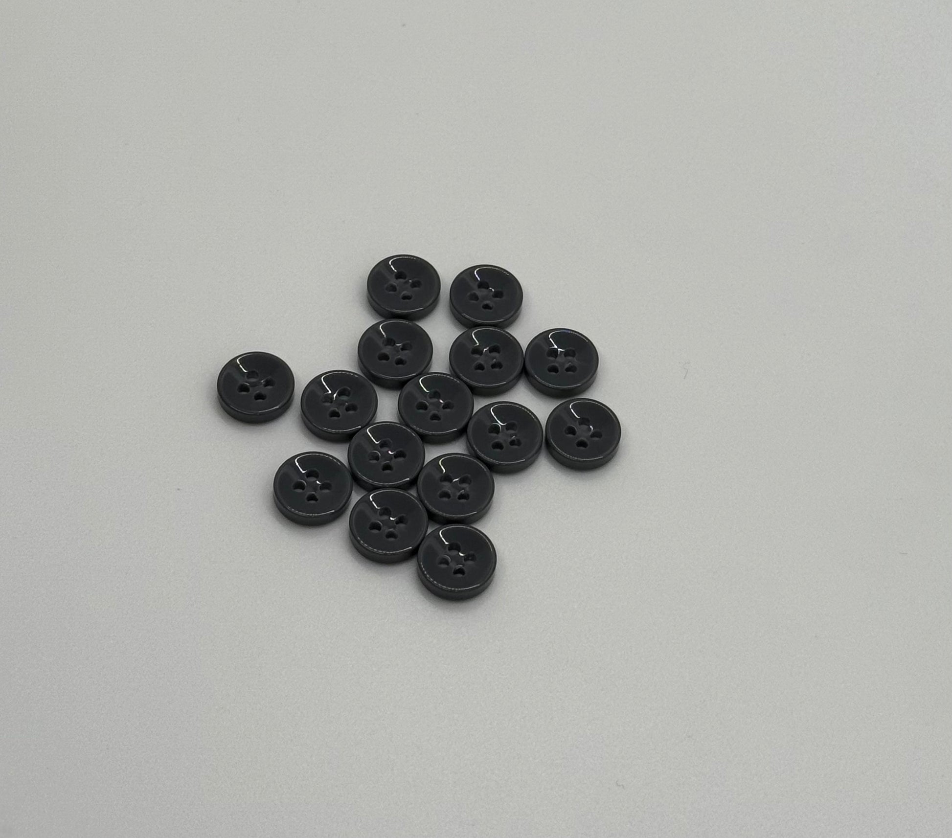 Close-up image of Urban Steel 4-Hole 18L Button, a premium quality button.
